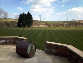 A broad open area cut to a consistent finish, with a roller at the edge of frame — the kind of ground gang and triple mowing is made for.