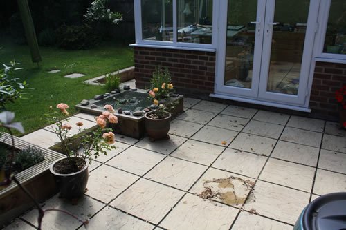 Bishop's Stortford — the finished patio outside the back doors, with planting set into the reworked bed alongside.